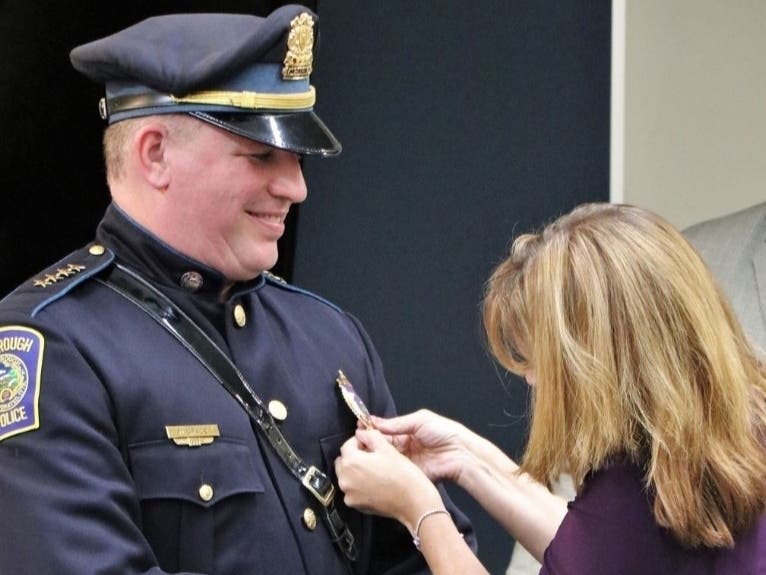 Michael Grace's police chief badge was pinned on his uniform by his wife, Kirsten, alongside their three children and his parents.