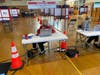 Poll workers protect themselves from the coronavirus with masks and glass shields during the Braintree special election