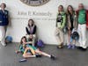 Jill Galus, standing in the group of three on the left, on one of the many trips she took her Girl Scouts on – this one to the John F. Kennedy Presidential Library and Museum in Boston. 