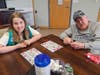 Amherst Girl Scouts donated cookies and the gift of time to play games with the veterans at the New Hampshire Home for Veterans.