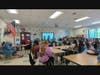 Alice Quigley, Annette Mathews, and Fiona Baxley present their Unplug & Reset Challenge to students at Dover Middle School. 