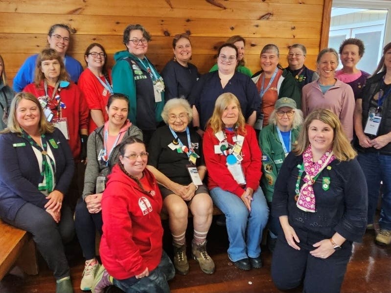 Vera Kirk, center seated, sits among Girl Scout council board members and volunteers honored for their membership and service at a volunteer recognition ceremony Sept. 26 in Thetford, VT.