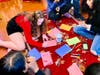 Volunteers are creating and decorating personalized holiday cards for foster care children.