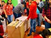 Volunteers are decorating and packaging gift boxes for foster care children.