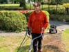Johnny power washes a walkway. 