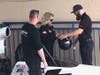 Funny Car Driver Chris King (L) and Frank Hawley instructor (R) help Erin Gallagher into a dragster.