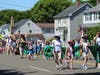 Hamden Girl Scouts marching alongside Girl Scouts of Connecticut Volunteers and Troop Leaders