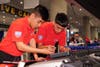 Students Isidoro and Castro work on their vehicle during the NATC finals 