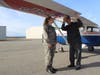 A CAP senior member shows a cadet how to inspect the plane prior to a flight.