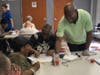 A member from The Fortune Society serves residents nutritious smoothies