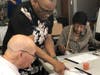 Guy Woodard teaches Harlem Center residents how to draw