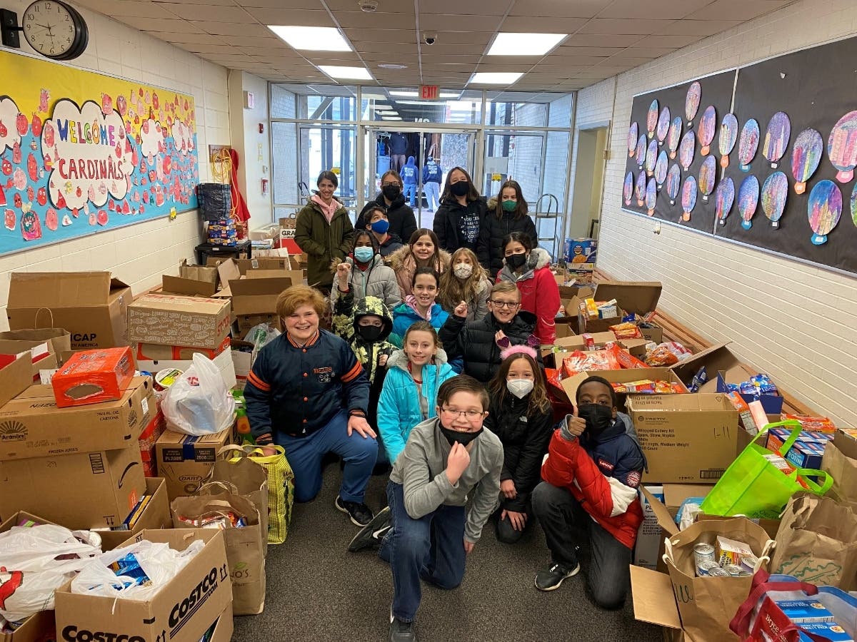 Members of the Palos West student council make a final tally of food donations before loading them on a truck headed to Palos Township.
