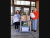 Palos South Middle School students Aleksandra and Nicole organize items for donation to Ukraine relief efforts.