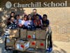 Palos West Elementary Principal Jennifer Peloquin delivers a donation of new shoes to students of Patricia Callahan at Winston Church Hill Elementary School.
