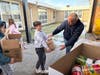 Palos West student council members load the donations they collected for their school's annual "Souperbowl" of Caring food drive.
