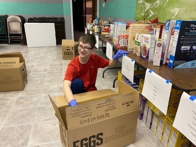 Nolan Torri, 16, prepares to clean, organize and pack donated goods aimed to help area families in need due to COVID-19.