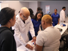 Dr. Anderson and Medical Assisting student, Novena Graham, illustrate the basics of performing CPR to Amy Truong (left, 