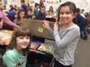 Third-grader Allison Pearson (right) shows her desk to her second-grade pen pal, Brooke McFadden.
