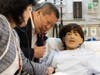Sen. Tony Hwang with SHU Nursing Dean Karen Daley jointly examine mock patient using teaching stethoscope