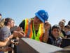 Mother signs steel beam at topping out ceremony.