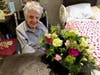 Wilda Wilson receives flowers from her granddaughter for her 105th birthday.