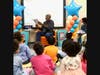 One of the many Real Men Read volunteers captivates primary school children of Matteson in a return performance to live sessions.