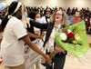 Southland students present Sherry Grutzius with flowers and a check.