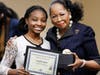 Southland CEO Dr. Blondean Y. Davis presents junior Danielle Mambo with her Golden Apple award recognition for earning straight.