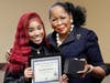 Southland CEO Dr. Blondean Y. Davis presents junior Kayla Robinson with her Golden Apple award recognition. She is one of 34 Southland College Prep students honored. 
 
