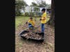 [l-r] Allison Hadley and Lily Meredith gathering tree debris from a yard in Pensacola