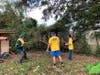 Elder Josh Isaksen, Ben Isaksen, and Tyler Hadley pulling down a fallen tree from a yard in Pensacola
