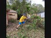 River Ridge High School Sophomore, Ben Isaksen, clearing out brush at a home in Pensacola.