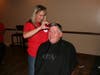 Mayor Jim Sexton gets the first hair cut in fundraiser for Christmas Without Cancer