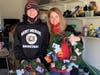 Christmas Without Cancer VP Renee Copeland and younger cousin Evan Blake prepare to bring a wreath of gift cards to a local family.