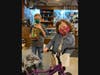 Charlotte Moran shows off her new bike while older brother Jaykeb secures the candy jar showcased at Marquette Bank over the holiday season. 