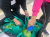 Center for Food Equity in Medicine volunteers pack grocery bags in the basement of the Flossmoor Community Church.