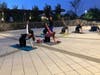 As Night Falls, Attendees Perform Their Guided Yoga Flow Under the Lights