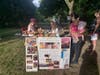 Adults and kids painting remembrance rocks