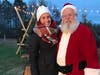 Owner Danielle Pohland poses with Santa Claus at her Snowball Stand business