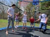 The Magee kids play on their families trampoline during the corona virus.
