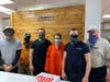 John Hofman along with his workers wear face masks as they prepare pizza's and other foods for carry out.