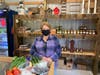 Deborah Hall stands in front of her fresh veggie & fruit box. Every week, her veggie boxes change depending on what is available. 