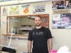 Owner, Oliver Janev, standing in front of his kitchen at OC Bites happy to have customers back after the town reopens. 