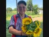 Farmer Bill Eason shows off sunflowers he just picked.