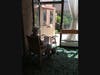 A resident enjoys listening to the cello music form a front row seat by the open door