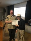 Historical Society Vice President Jerry Cody presents a certificate of appreciation to Tony Pierucci. 