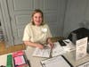 Historical society member Lexi Walt serves as the meeting's greeter. 