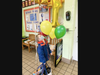 Young scholar appreciates the balloons, signage, and a cookie that defined school-wide celebration of the "Best of Bethesda" wins. 