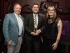 AMA Chicago President Chris McGuire with Taylor Kraft and Megan Ward from StudioNorth as they accept the 2026 Palmer Marketing Award for Momentum for "Lenovo's Accelerating Your AI Journey Video Podcast Series" 