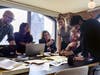 Luci team members working together at the new London office. Left to Right: Matthew McNerney, Alice Penner, AJ Goehle, Becca Warren, Josh Kirk, and Thomas Tzortzi